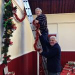 Graham and Mike hanging Xmas decorations
